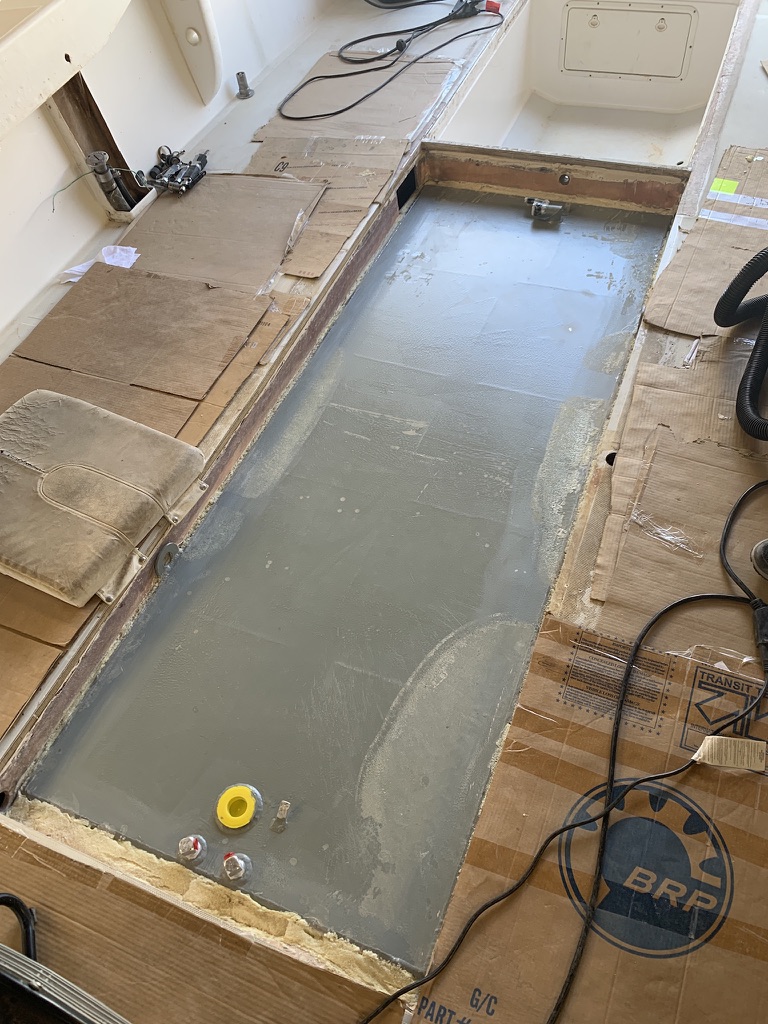 Cleaned and prepared fiberglass tank compartment in an opened boat deck during fuel tank replacement